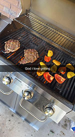 picture of a grill with steak and peppers on it with text going across saying "God I love grilling"